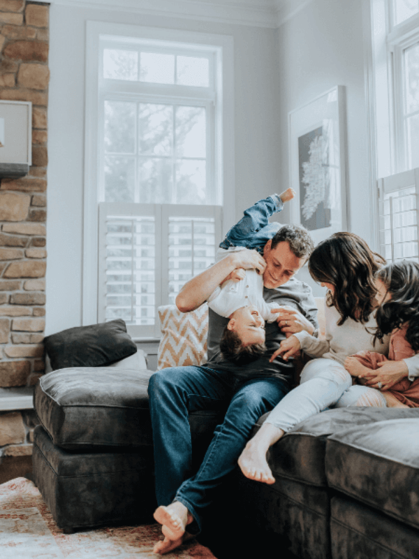 A happy family enjoying their freshly cleaned home in Austin, TX, thanks to Pure Magic Maids.