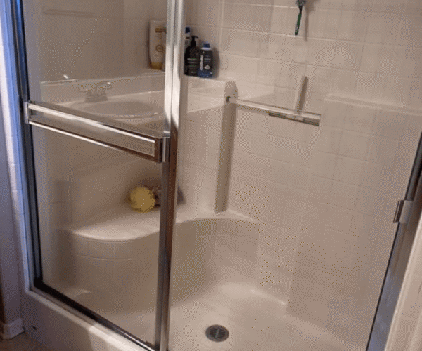 A professionally cleaned standard shower in Austin, TX, featuring a spotless tub and tile.
