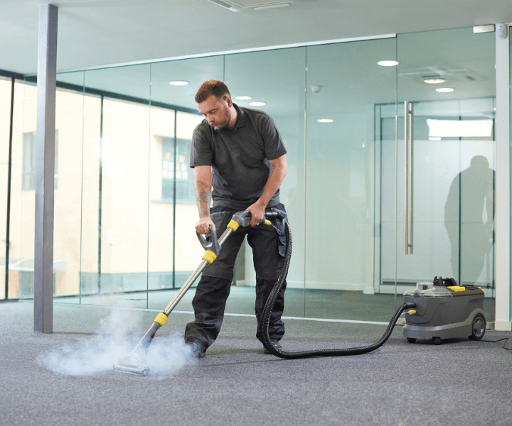 A professional cleaning a commercial carpet in Austin, TX.