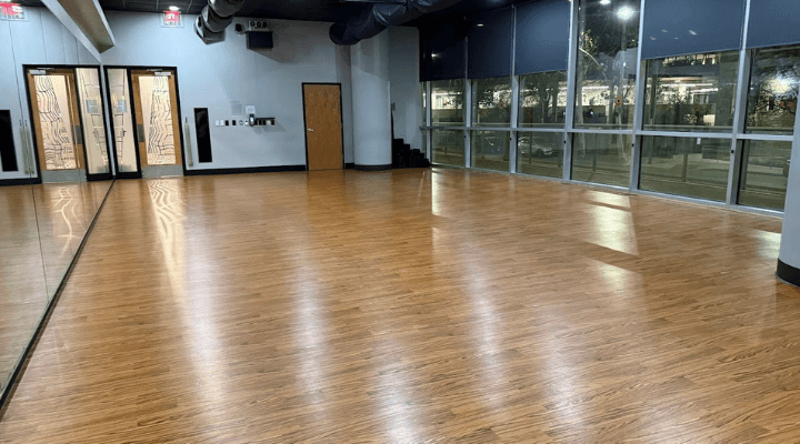 A clean and polished gym floor in a yoga or ballet studio in Austin, TX.