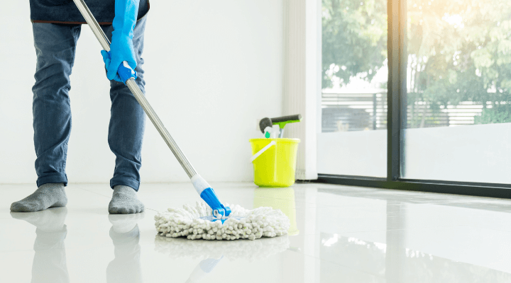 A janitor mopping the lobby floor of a commercial office in Austin, TX.
