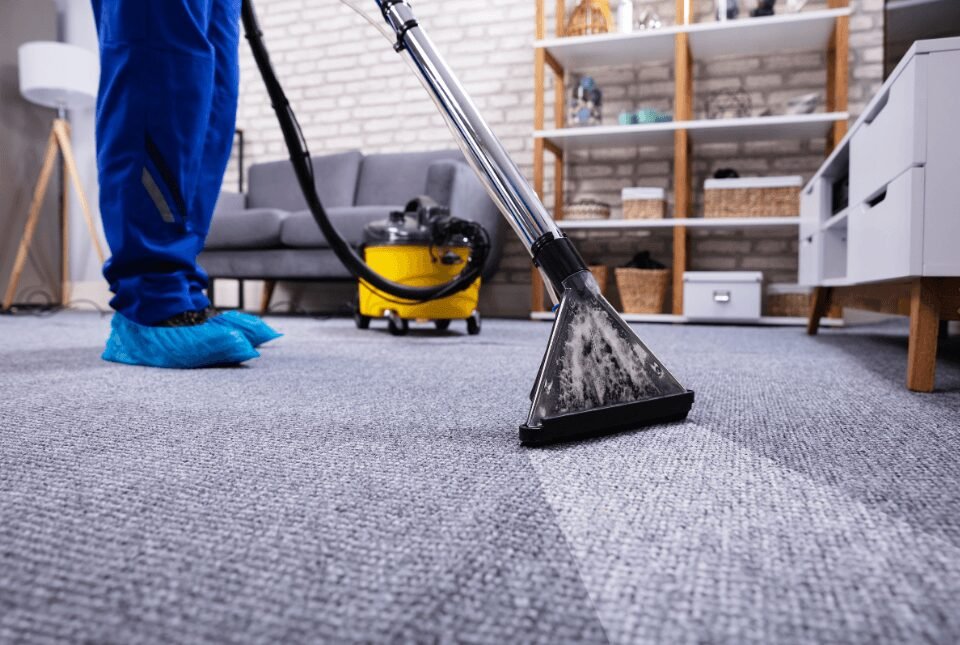 A professional cleaner using a steam carpet cleaner on an office carpet in Austin, TX.
