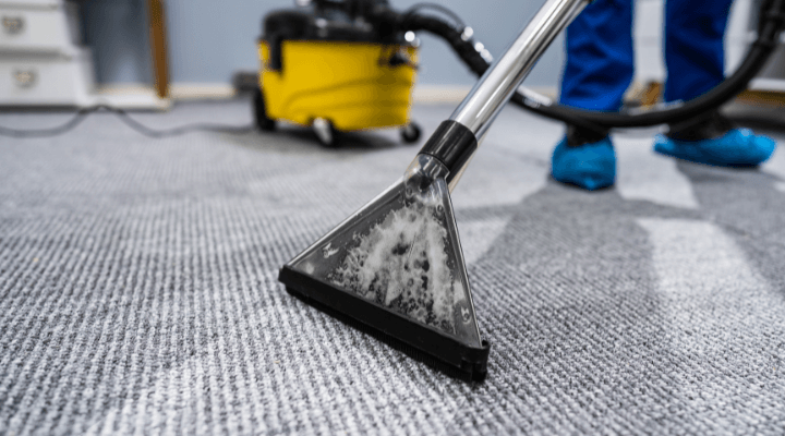 A professional steam cleaning an office carpet in Austin, TX.